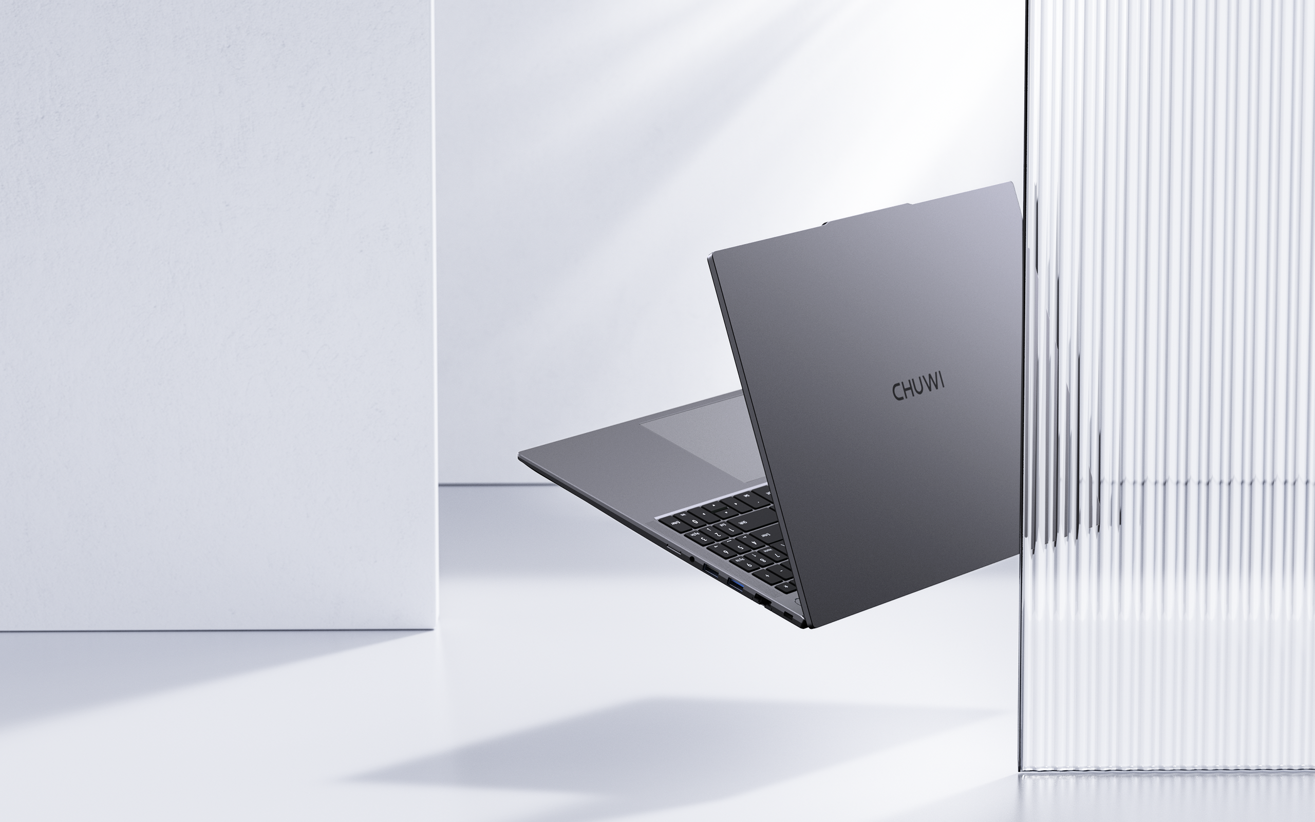 CoreBook Plus laptop in open position showing 16-inch display